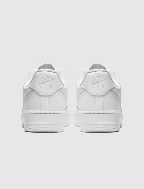 Back view of white low-top sneakers with classic stitching and logo detail on heel