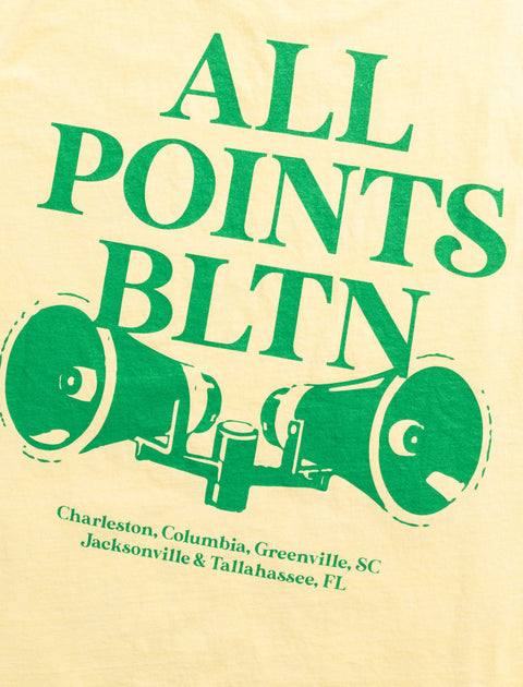 Yellow streetwear tee with green 'ALL POINTS BLTN' text, megaphone graphic, and city names.