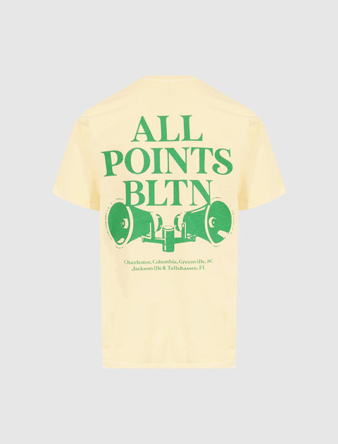 Yellow streetwear t-shirt with bold green 'ALL POINTS BLTN' graphic and city names on back