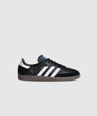 Black and white low-top sneaker with gum sole and three side stripes, isolated on white