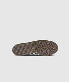 Closeup of brown Adidas sneaker sole with geometric tread pattern and circular grip details
