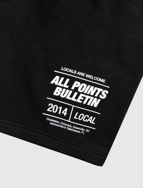 Black streetwear t-shirt with bold white 'All Points Bulletin' local cities text print.